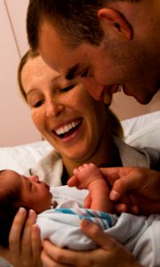 US Navy 100211-N-7498L-025 Air Force 1st Lt. Brandon Wilson and his wife greet a new addition to their family at Tripler Army Medical Center