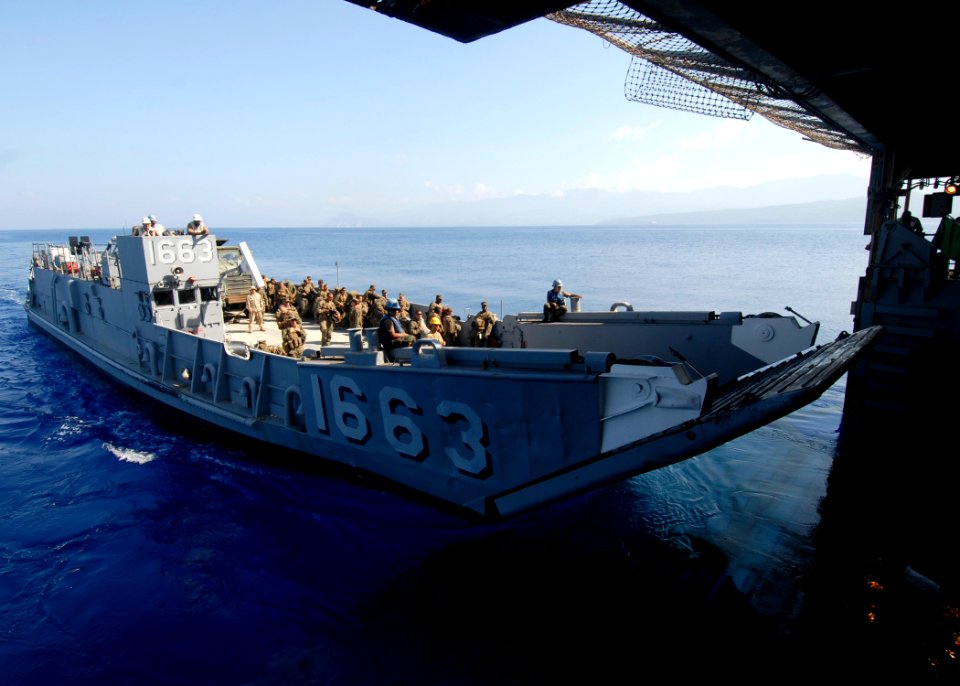 US Navy 100212-N-2000D-350 Landing Craft Unit (LCU) 1663, assigned to Assault Craft Unit (ACU) 4, departs the amphibious dock landing ship USS Carter Hall (LSD 50)
