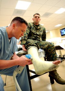 US Navy 100211-N-6326B-126 Naval Medical Center San Diego orthopedic resident Lt. Todd A. Fellers removes a cast from Cpl. Brent R. Wommack in the orthopedic acute care ward