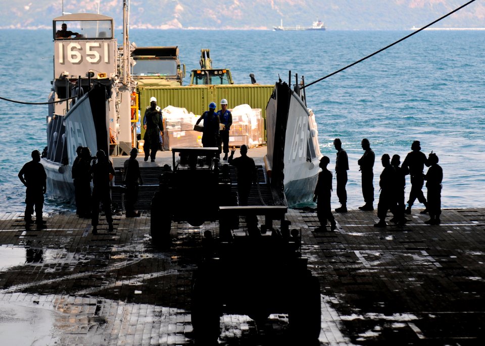 US Navy 100212-N-9950J-123 Sailors and Marines unload supplies aboard USS Essex