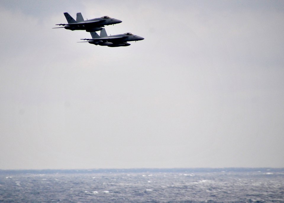 US Navy 100213-N-4774B-026 wo F-A-18E Super Hornets assigned to the Sunliners of Strike Fighter Squadron (VFA) 81 fly in formation over the Nimitz-class aircraft carrier USS Carl Vinson (CVN 70)