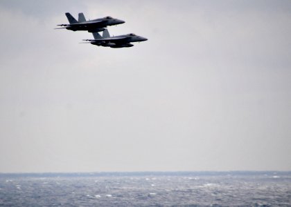 US Navy 100213-N-4774B-026 wo F-A-18E Super Hornets assigned to the Sunliners of Strike Fighter Squadron (VFA) 81 fly in formation over the Nimitz-class aircraft carrier USS Carl Vinson (CVN 70)