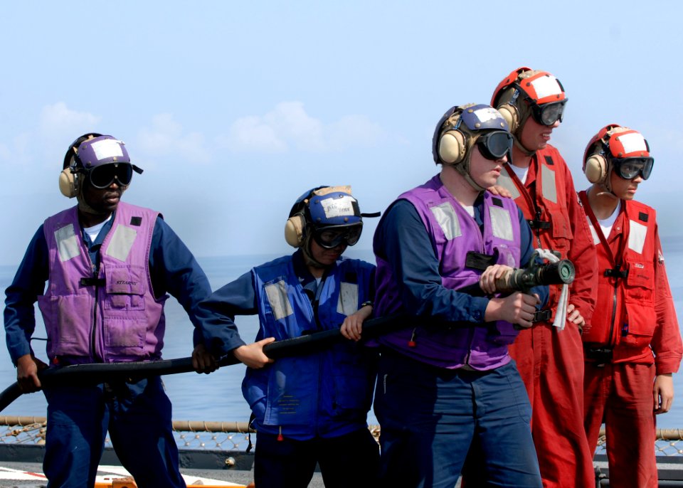 US Navy 100215-N-2000D-089 Sailors man an aqueous film forming foam hose during a crash and salvage drill aboard the amphibious dock landing ship USS Carter Hall (LSD 50)