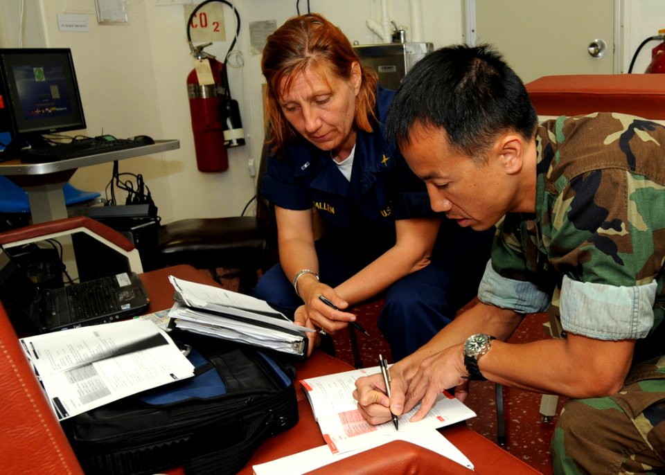 US Navy 100217-N-6676S-012 Lt. Brandon Le takes notes as Chief Warrant Officer 3 Eve McAnallen instructs him on advanced French