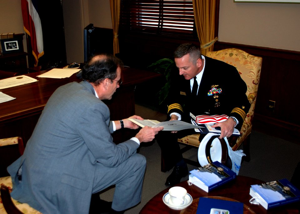 US Navy 100218-N-8750E-131 Mississippi Secretary of State Delbert Hosemann, left, presents a state flag that was flown over the capitol building