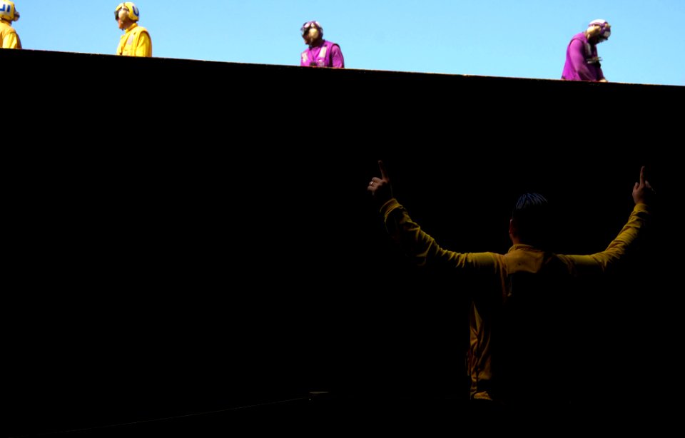 US Navy 100218-N-8822R-045 Aviation Boatswain's Mate (Handling) 2nd Class Noe Galarzapadilla signals an aircraft elevator operator during a mass casualty drill aboard USS Carl Vinson (CVN 70)