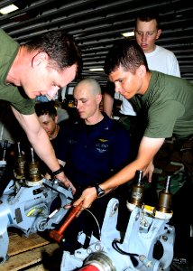 US Navy 100218-N-4649B-028 Sailors and Marines aboard USS Bataan (LHD 5) reassemble helicopter blade spindles in the ship's hangar bay