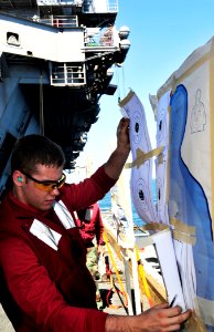 US Navy 100219-N-3595W-009 Gunners Mate 3rd Class Bryan Slabaugh tallies his shooting score after participating in small arms qualifications aboard the aircraft carrier USS Dwight D. Eisenhower (CVN 69)