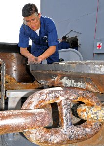 US Navy 100215-N-1082Z-039 Boatswain's Mate Seaman Andrew Sanchez, from Phoenix, Ariz., prepares to paint part of the focsle