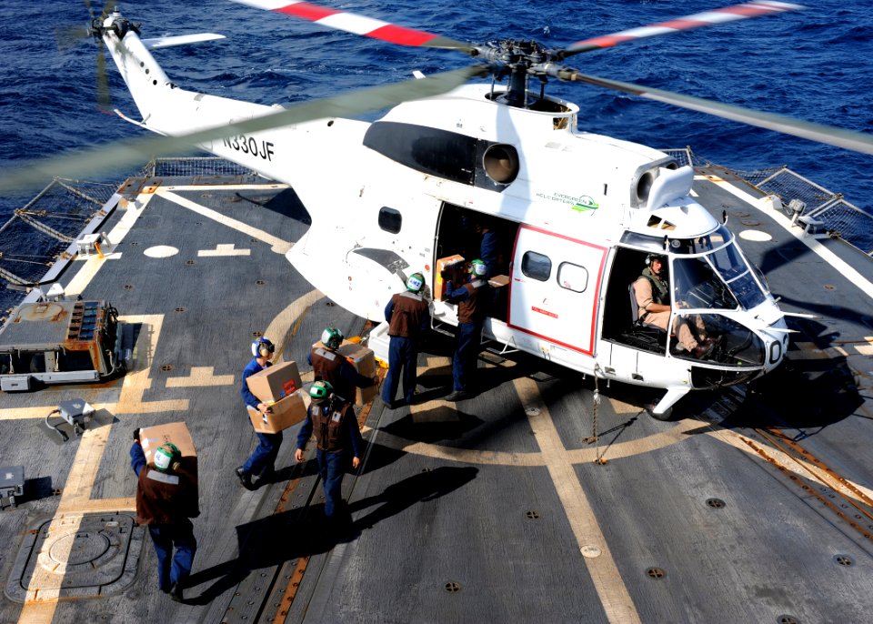 US Navy 100219-N-7088A-029 Sailors aboard USS Farragut (DDG 99) load mail onto a helicopter