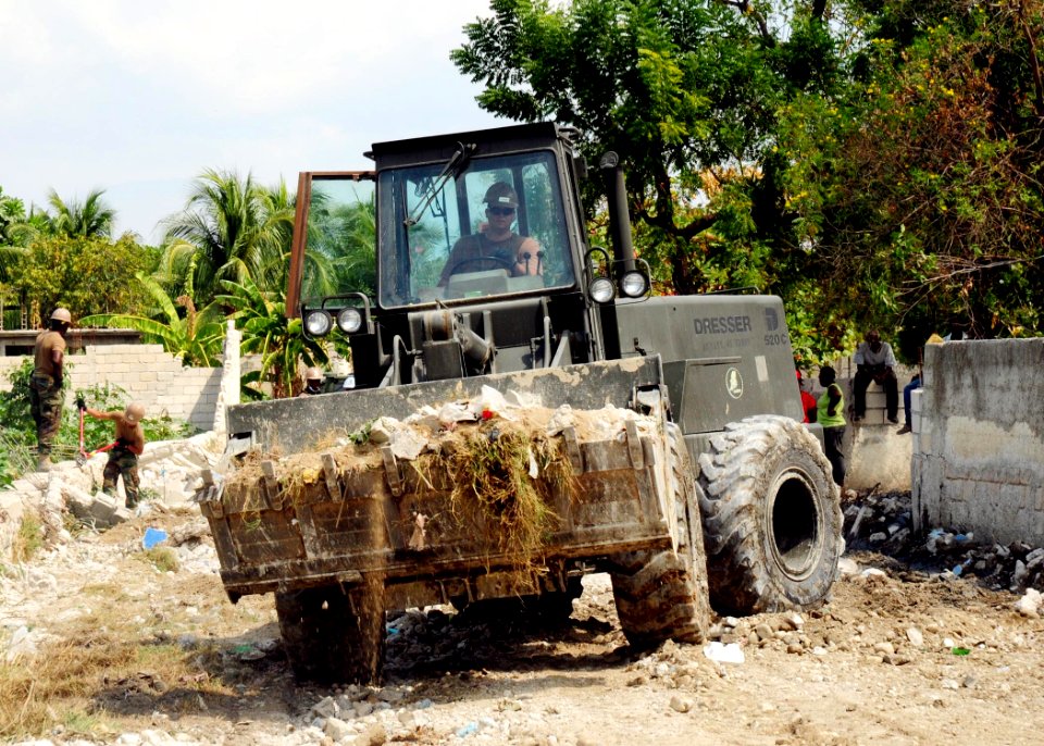 US Navy 100216-N-9643W-068 A Seabee assigned to Amphibious Construction Battalion (ACB) 2 removes rubble near Toussaint Louverture International Airport in Port-au-Prince, Haiti