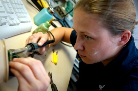 US Navy 100219-N-5712P-038 Electronics Technician 3rd Class Christine Duncan, from Richmond, Va., repairs a flight deck cranial hydra system before flight quarters aboard the amphibious assault ship USS Nassau (LHA 4)