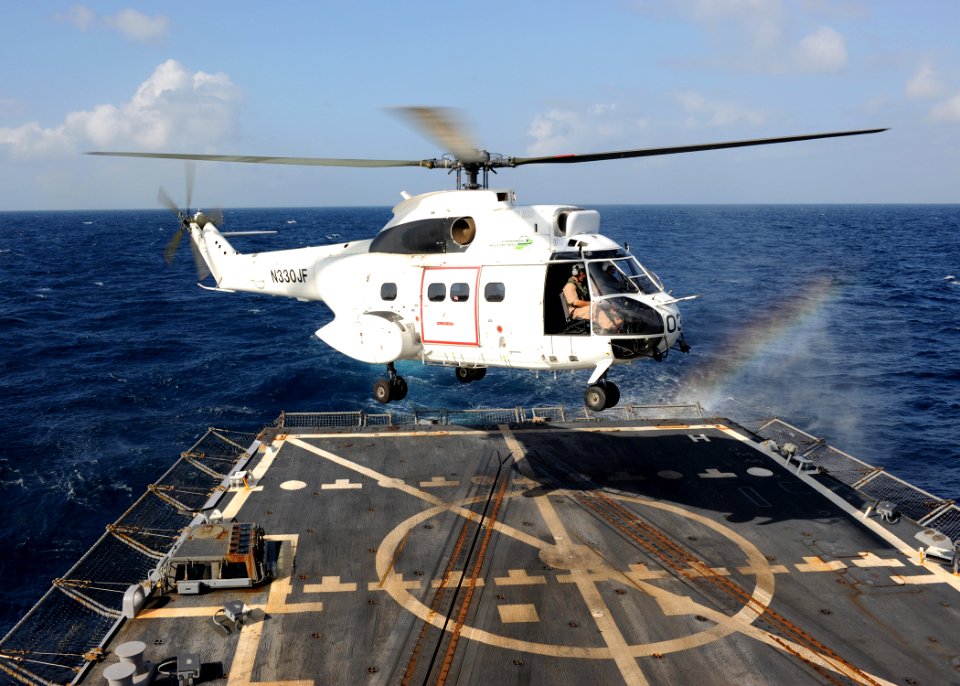 US Navy 100219-N-7088A-008 A helicopter lands aboard USS Farragut (DDG 99) during a vertical replenishment at sea