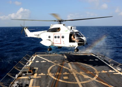 US Navy 100219-N-7088A-008 A helicopter lands aboard USS Farragut (DDG 99) during a vertical replenishment at sea