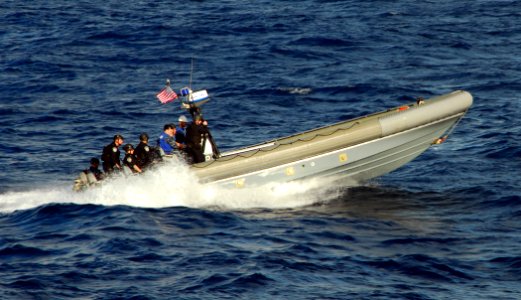 US Navy 100217-N-7058E-175 A rigid-hull inflatable boat carries Sailors and Coast Guardsmen from the littoral combat ship USS Freedom (LCS 1)