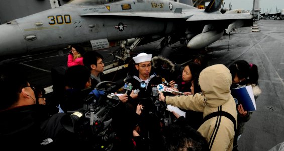 US Navy 100217-N-3038W-131 Aviation Machinist's Mate Airman Wingcheung Lam, assigned to the Black Aces of Strike Fighter Squadron (VFA) 41, takes part in a press conference aboard the aircraft carrier USS Nimitz (CVN 68)