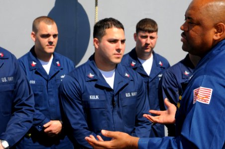 US Navy 100220-N-1688B-127 Capt. Anthony Swain, commanding officer of the guided-missile cruiser USS Hue City (CG 66) answers questions from Sailors after a uniform inspection photo