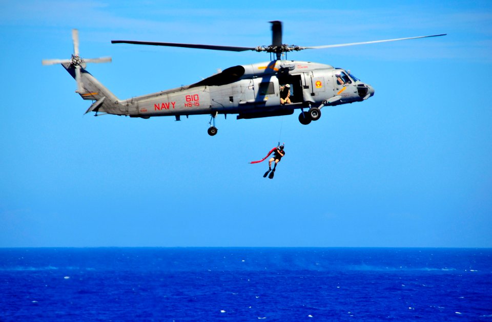 US Navy 100216-N-4774B-760 A search and rescue swimmer is lowered from an SH-60F Sea Hawk helicopter