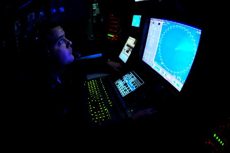 US Navy 100218-N-2953W-100 Operations Specialist 3rd Class Eric Konnight stands an identification operations watch in the combat directions center