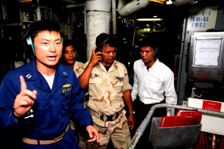 US Navy 100218-N-8335D-013 Lt. Sung Choi gives Royal Cambodian navy officers Lt. Cmdr. Chea Korm and Lt. Cmdr. Im Saroeun a tour of the auxiliary machinery room of USS Patriot (MCM 7) photo