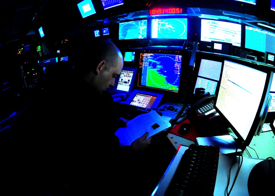 US Navy 100218-N-2953W-156 Lt. John Howard reviews information in the combat directions center aboard USS Carl Vinson (CVN 70)