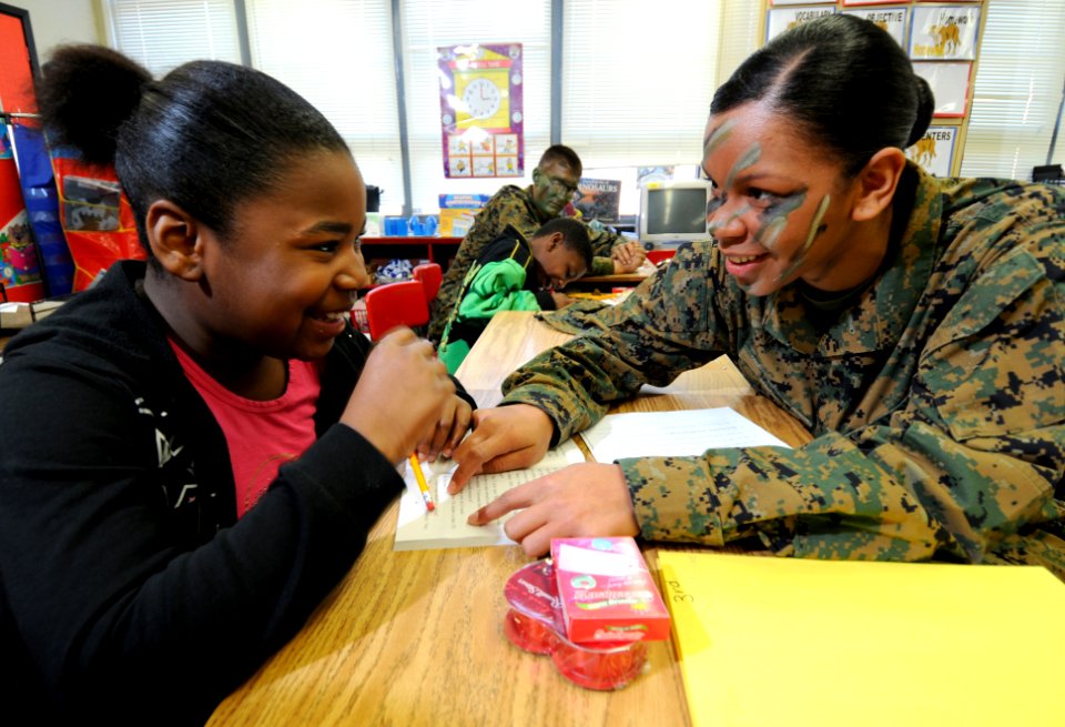 US Navy 100220-N-5328N-260 Lance Cpl. Chenelle McGee asks a student questions about the story she's reading during the 50th session of Saturday Scholars at Montclair Elementary School