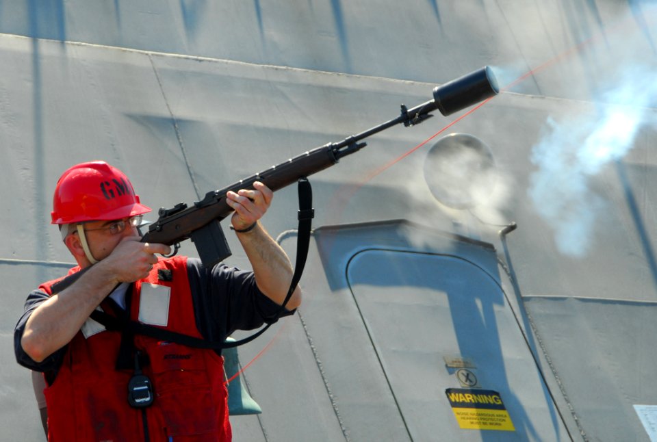 US Navy 100220-N-7058E-309 Chief Gunners Mate Joshua Gordon, assigned to the littoral combat ship USS Freedom (LCS 1) fires a shot line to the Military Sealift Command fleet replenishment oiler USNS Leroy Grumman