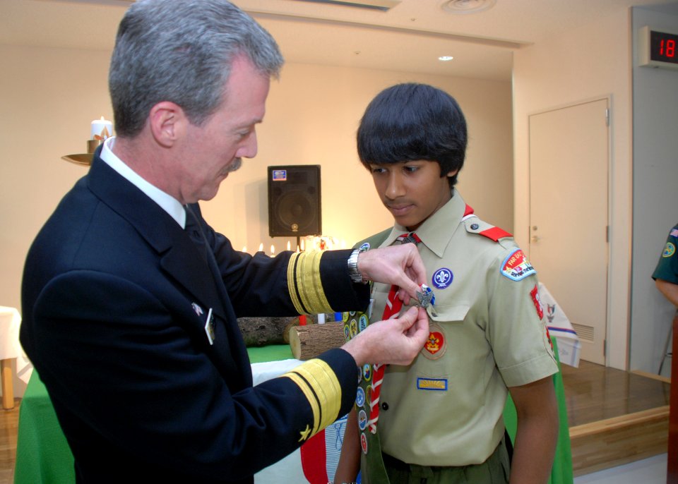 US Navy 100218-N-3283P-065 Rear Adm. Richard Wren, commander of U.S. Naval Forces Japan, pins an Eagle Scout badge on Nigal Shah, a member of the Far East Council, Boy Scouts of America Japan District, Troop 35