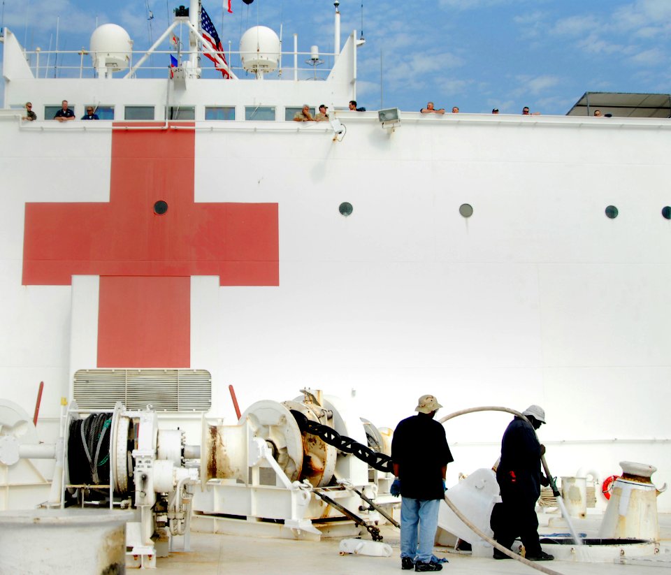 US Navy 100221-N-4047W-018 Civilian mariners aboard the Military Sealift Command hospital ship USNS Comfort (T-AH 20) wash down the port anchor chain during a sea and anchor detail as the ship prepares to get underway