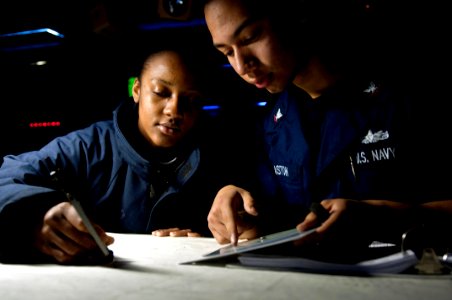 US Navy 100219-N-5712P-047 Operations Specialist 2nd Class Jodi Ann Miller, from Kingston, Jamaica, and Operations Specialist 3rd Class Josean Gaston, from Fayetteville, N.C
