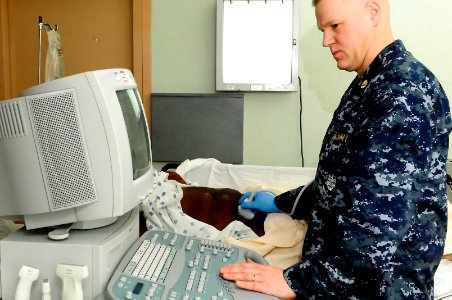 US Navy 100219-N-4378P-031 Chief Hospital Corpsman Mike Nienow, a radiologist technician from Rochester, Minn., performs a venous ultrasound on a Haitian woman aboard the Military Sealift Command hospital ship USNS Comfort (T-A