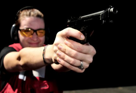 US Navy 100219-N-3595W-001 Gunner's Mate 1st Class Ashley Sheriff demonstrates proper aiming techniques during small arms qualifications aboard the Nimitz-class aircraft carrier USS Dwight D. Eisenhower (CVN 69)