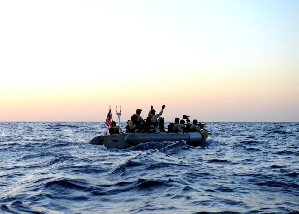 US Navy 100221-N-7088A-113 Sailors signal a Somali skiff with suspected pirates to raise their hands before boarding