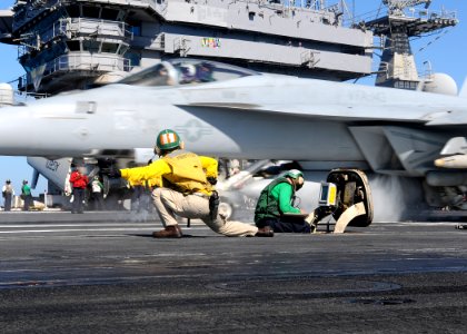 US Navy 100220-N-4236E-225 Lcdr. Kim DaCosta launches an F-A-18E Super Hornet assigned to the Pukin Dogs of Strike Fighter Squadron (VFA) 143 from the Nimitz-class aircraft carrier USS Dwight D. Eisenhower (CVN 69)