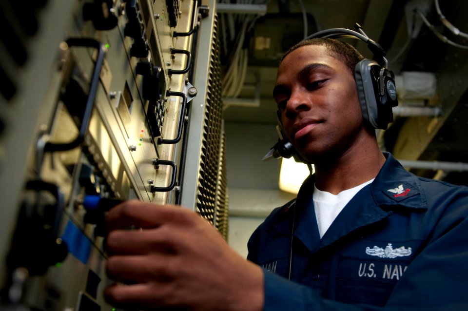 US Navy 100219-N-5712P-032 nformation Systems Technician 2nd Class Jibril Holman, from St. Louis, tests a high frequency circuit receiver before the amphibious assault ship USS Nassau (LHA 4) transits the Strait of Gibraltar