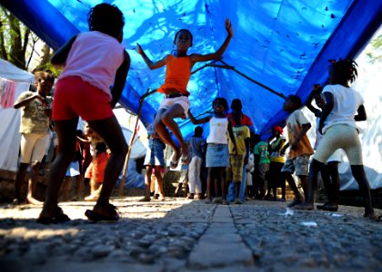 US Navy 100222-N-5961C-009 Haitian children enjoy jumping rope under the shelter of a tarp in their temporary neighborhoods