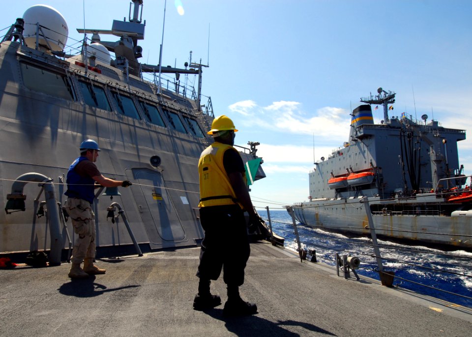 US Navy 100220-N-7058E-381 Chief Logistics Specialist Keith Wilkerson, assigned to the littoral combat ship USS Freedom (LCS 1) signals the Military Sealift Command fleet replenishment oiler USNS Leroy Grumman
