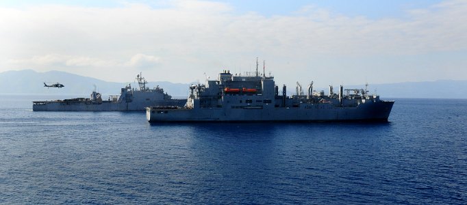 US Navy 100220-N-7508R-420 The dock landing ship USS Carter Hall (LSD 50) sails alongside the Military Sealift Command dry cargo-ammunition ship USNS Sacagawea (T-AKE 2) during a vertical replenishment