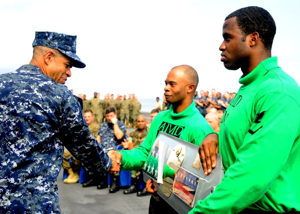 US Navy 100219-N-8655E-402 Capt. Sam Howard is presented his command pennant on behalf of the crew of SS Bataan (LHD 5) during a change of command ceremony