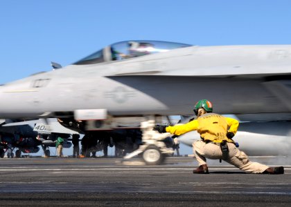 US Navy 100220-N-4236E-274 Lcdr. Kim DaCosta, launches an F-A-18E Super Hornet from the Pukin Dogs of Strike Fighter Squadron (VFA) 143, from the flight deck of the Nimitz-class aircraft carrier USS Dwight D. Eisenhower (CVN 69