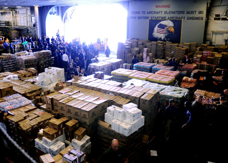 US Navy 100220-N-4649B-004 Sailors and Marines aboard the multipurpose amphibious assault ship USS Bataan (LHD 5) move more than 250 pallets of food and supplies