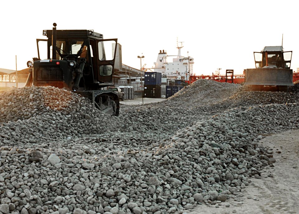 US Navy 100223-N-9643W-037 Seabees assigned to Amphibious Construction Battalion (ACB) 2 pour gravel at the White Beach logistical compound