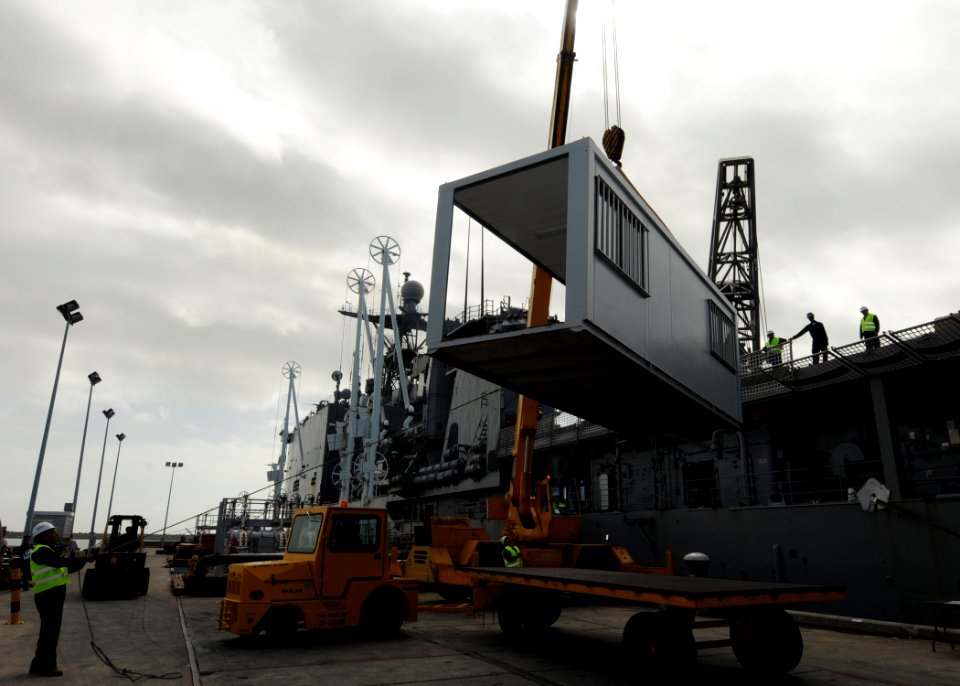 US Navy 100224-N-6676S-111 A section of a portable classroom is craned aboard the amphibious dock landing ship USS Gunston Hall (LSD 44)