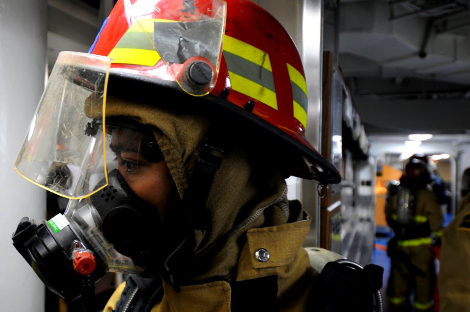 US Navy 100224-N-7948R-106 Machinist'S Mate 2nd Class Edward Cabansag participates in a class bravo fire drill during general quarters aboard the amphibious assault ship USS Peleliu (LHA 5)