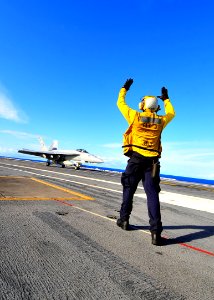 US Navy 100222-N-2953W-369 A plane director signals an F-A-18 Super Hornet assigned to the Sunliners of Strike Fighter Squadron (VFA) 81 aboard the aircraft carrier USS Carl Vinson (CVN 70)