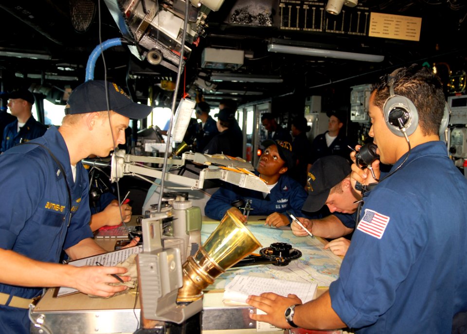 US Navy 100222-N-6692A-006 Sailors aboard the amphibious dock landing ship USS Harpers Ferry (LSD 49) plot the ship's course as she enters Singapore Harbor during a scheduled port visit