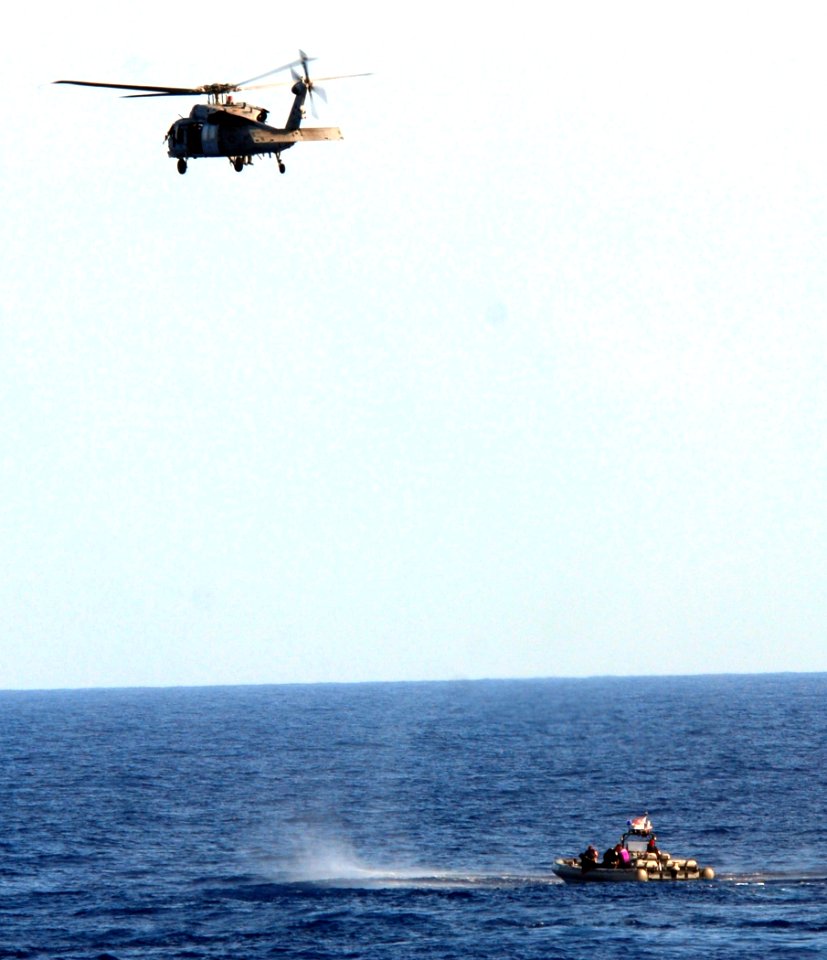 US Navy 100222-N-7058E-249 An MH-60S Sea Hawk helicopter assigned to Helicopter Sea Combat Squadron (HSC) 22 hovers over the position of illicit drugs dumped overboard by the crew of a high-speed