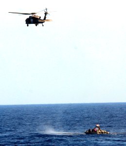 US Navy 100222-N-7058E-249 An MH-60S Sea Hawk helicopter assigned to Helicopter Sea Combat Squadron (HSC) 22 hovers over the position of illicit drugs dumped overboard by the crew of a high-speed