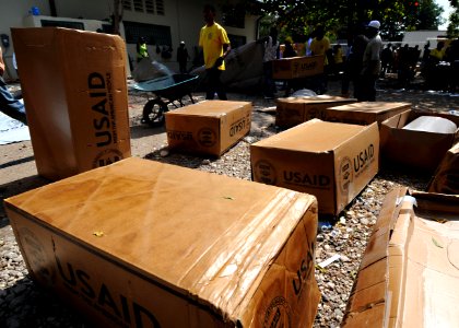 US Navy 100224-N-5961C-006 Haitian citizens prepare plastic sheeting for distribution in Port-au-Prince photo