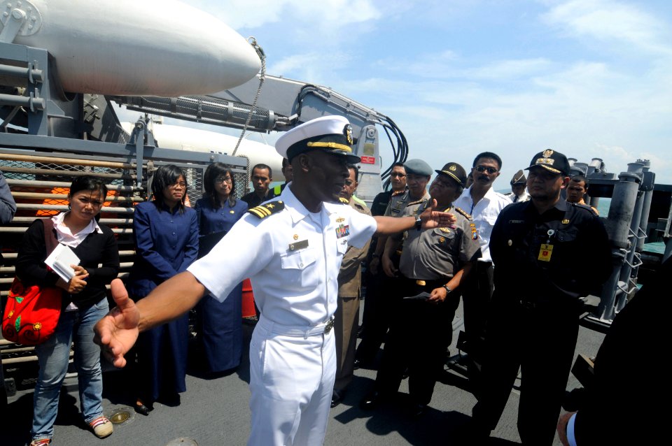 US Navy 100225-N-8335D-723 Lt. Cmdr. Walter Mainor, commanding officer of the mine counter-measures ship USS Patriot (MCM 7), explains fantail equipment while giving a tour of the ship. Patriot is on spring patrol
